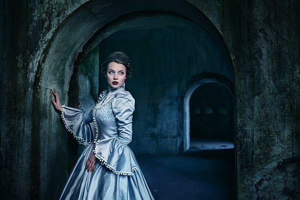 Woman Blue gown stone corridor iStock