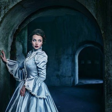 Woman Blue gown stone corridor iStock